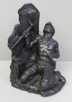 A carved coal figure of a miner working at the coalface, signed and dated