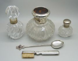 A sterling silver spoon, a perfume bottle with silver top, Birmingham 1891, a silver brush,