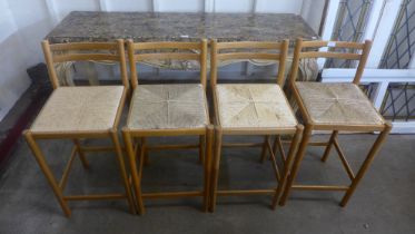 A set of four beech and cane bar stools