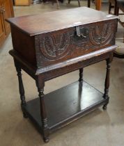 A George II carved oak Bible box on stand, with two 19th Century Bibles