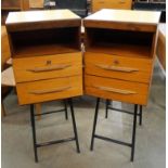 A pair of teak cabinets and black tubulor metal stands