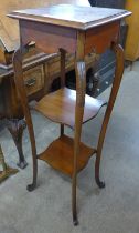 An Edward VII walnut three tier jardiniere stand