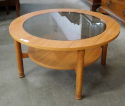 A teak and glass topped circular coffee table