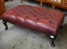 A large oxblood red leather footstool