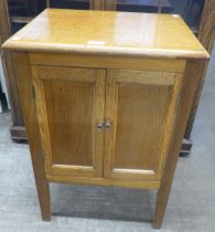 A small oak two door cupboard