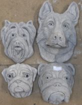 Four concrete dogs heads