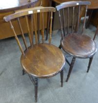 A pair of Victorian beech penny seat kitchen chairs