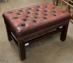 A mahogany and oxblood red leather Chesterfield footstool