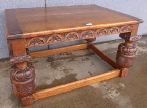 An Elizabethan style carved oak coffee table