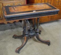 A Victorian ebonised and amboyna rectangular fold over card table, manner of Lambs, Manchester