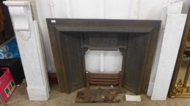 A Victorian style cast iron fireplace with marble decor