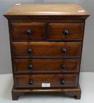A miniature Victorian style hardwood chest of drawers