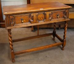 An early 20th Century oak geometric moulded barleytwist single drawer single drawer side table