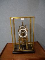 A cased gilt metal fusee cathedral skeleton clock