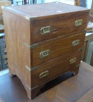 A small campaign style teak and brass mounted chest of drawers