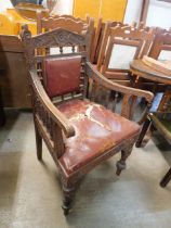 A Victorian Aesthetic Movement carved oak elbow chair