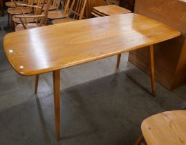 An Ercol Blonde elm and beech plank top dining table
