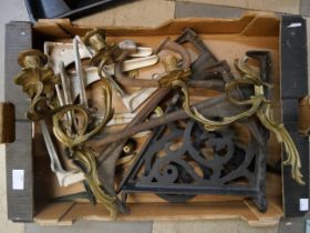 A collection of cast iron brackets and a pair of brass wall sconces