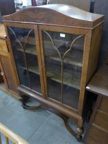 A Queen Anne style walnut two door bookcase