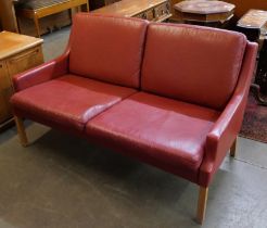 A Danish Thams crimson leather two seater sofa, designed by Rud Thygesen