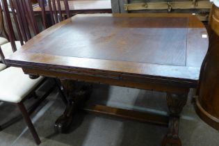 A carved oak draw-leaf table