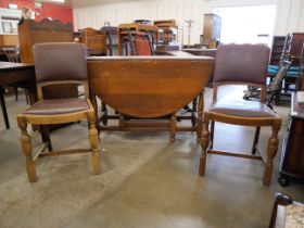 An oak gateleg table and two chairs