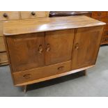 An Ercol Blonde elm and beech Windsor sideboard