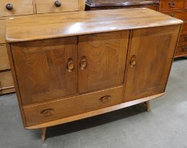 An Ercol Blonde elm and beech Windsor sideboard