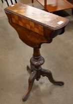 A Victorian inlaid walnut drop leaf tripod games table