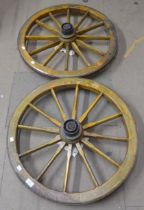 A pair of wooden barrow wheels