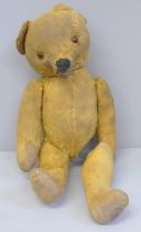 An antique vintage straw filled Teddy bear with pointed snout