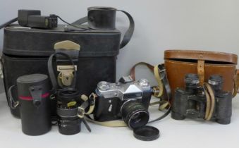 A pair of Werco 8 x 30 binoculars, cased and a Zenit-E film camera and a spare 135mm lens