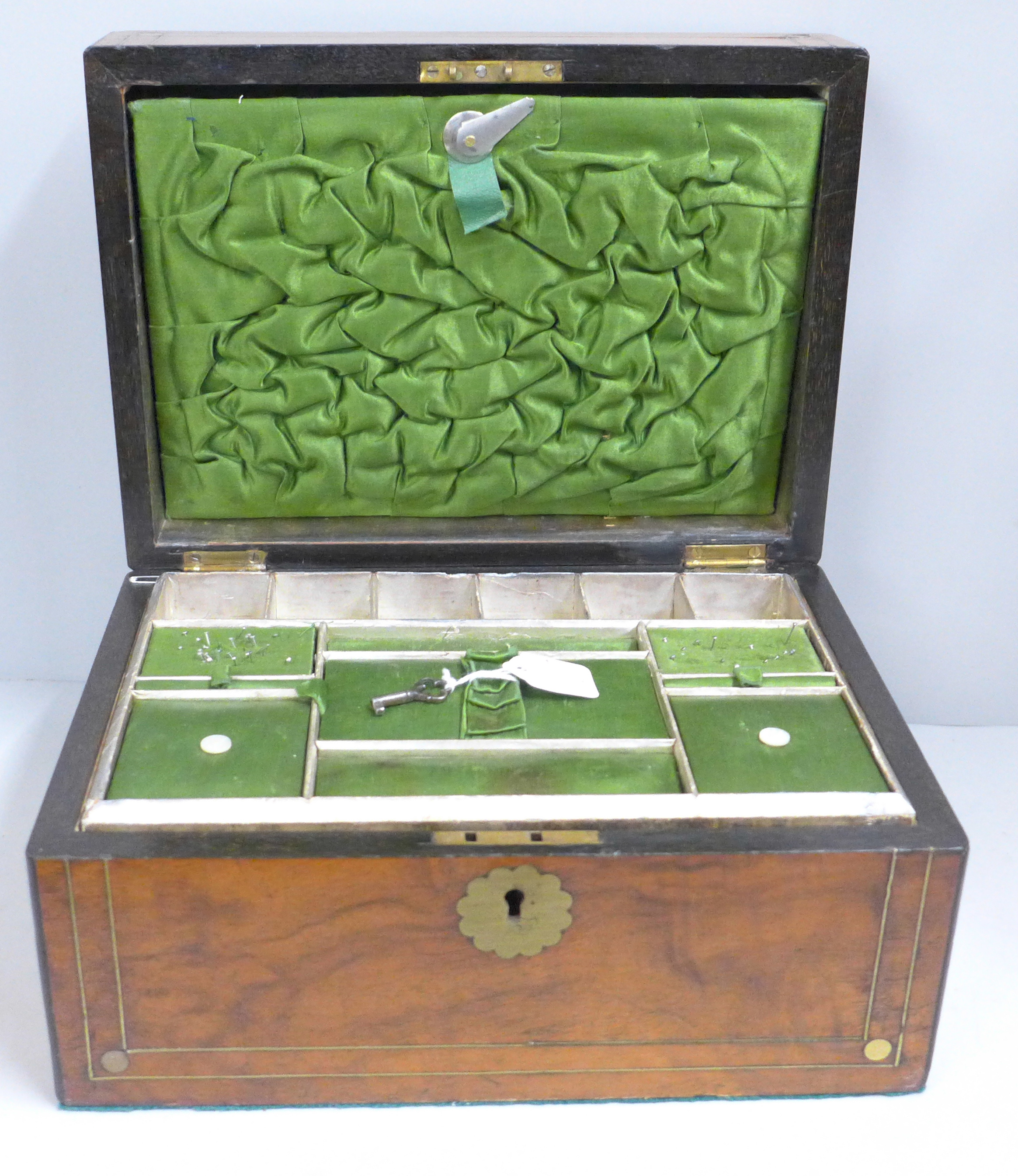 A lady's Victorian walnut workbox with brass inlay, original interior and key