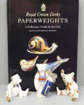 Three Royal Crown Derby paperweights, Golfer Bear, two others and a Collector's Guide