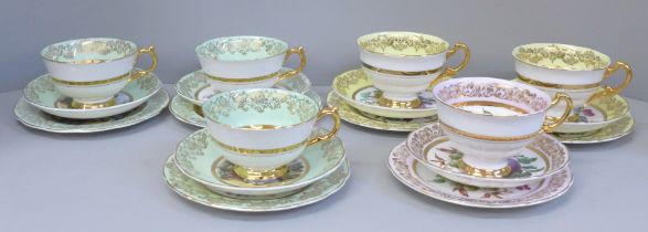 An Ashley bone china set of six cups, saucers and tea plates, decorated with fruit and with 22kt