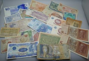 A collection of old bank notes including Bank of Mauritius, Germany, Denmark, Bank of Yugoslavia,