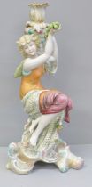 A continental porcelain figural candlestick modelled as a girl seated on a tree stump holding up a