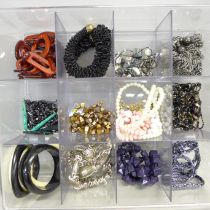 A box of modern costume jewellery; bangles, beads and necklaces