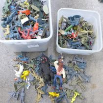 Two tubs of plastic toy soldiers and other plastic figures