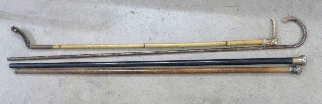 Two silver top walking cans, a riding crop and a bamboo walking stick
