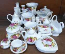 A large quantity of Cottage Rose china, including a swan, iron, bell, vases, etc., two Staffordshire