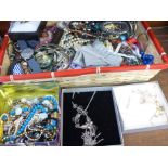 A basket of costume jewellery and watches