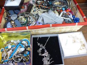 A basket of costume jewellery and watches