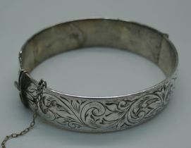 An engraved silver bangle, 47g