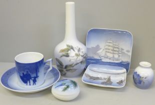 A Royal Copenhagen bottle vase, cup and saucer "Bringing Home The Christmas Tree", circa 1980, a
