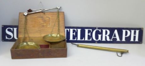 A Sunday Telegraph enamel metal sign, 76cm and a set of balance scales
