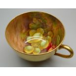 A Royal Worcester gilt tea cup with hand painted interior decorated with grapes and cherries, signed