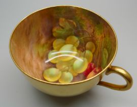 A Royal Worcester gilt tea cup with hand painted interior decorated with grapes and cherries, signed