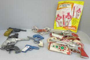 A collection of toy pistols, including cap guns