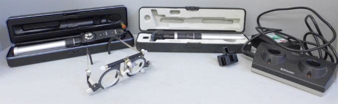 Two Keeler portable ophthalmoscopes, one marked 'Specialist', other marked 'Professional', both